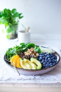 Glow bowl with berries and green leafs for daily wellnes